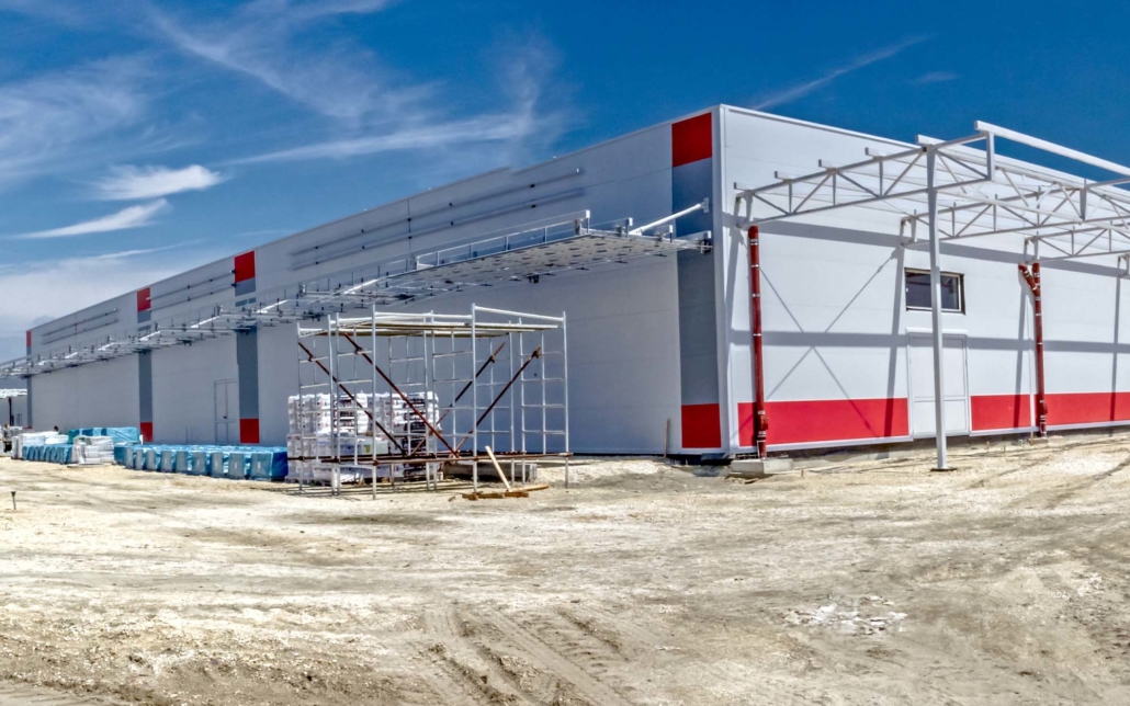 Mid process construction of a large red and white warehouse