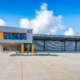 Modern industrial warehouse and office facility with multiple roller doors